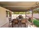 This covered patio area features a dining table, chairs and grill in the backyard at 5833 N 10Th St, Phoenix, AZ 85014