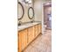 Bathroom featuring double sinks, granite countertops, and walk-in tiled shower at 6885 E Cochise Rd # 129, Paradise Valley, AZ 85253