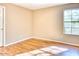 Neutral bedroom with hardwood floors and a window offering natural light at 6885 E Cochise Rd # 129, Paradise Valley, AZ 85253