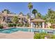 Inviting community pool area with lounge chairs, palm trees, and well-maintained surroundings at 6885 E Cochise Rd # 129, Paradise Valley, AZ 85253