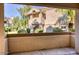 View from patio to building exterior surrounded by greenery, offering a tranquil outdoor space at 6885 E Cochise Rd # 129, Paradise Valley, AZ 85253