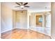 Spacious living room featuring hardwood floors, ceiling fan, and adjacent rooms with connecting doorway at 6885 E Cochise Rd # 129, Paradise Valley, AZ 85253