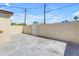Enclosed backyard area featuring a concrete patio, block wall, and gated access, perfect for outdoor living at 701 W Windsor Ave, Phoenix, AZ 85007