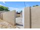 View of the entrance to the backyard, showcasing the secure block wall and gated access at 701 W Windsor Ave, Phoenix, AZ 85007