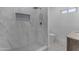 Modern bathroom features a shower with marble tile and gold fixtures, as well as a vanity at 701 W Windsor Ave, Phoenix, AZ 85007