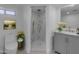 Modern bathroom featuring a walk-in shower with gold fixtures and marble countertops at 701 W Windsor Ave, Phoenix, AZ 85007