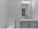 Updated bathroom features a marble vanity, modern mirror, and new toilet for a sleek, modern feel at 701 W Windsor Ave, Phoenix, AZ 85007