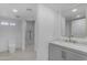 Bathroom featuring an elegant vanity with gold fixtures, a toilet, a modern shower, and ample lighting at 701 W Windsor Ave, Phoenix, AZ 85007