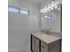 This bathroom features a dark wood vanity, a rectangular mirror, and a modern light fixture at 701 W Windsor Ave, Phoenix, AZ 85007