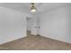 This bedroom offers wood-look floors, white walls, and a ceiling fan at 701 W Windsor Ave, Phoenix, AZ 85007