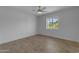Bright bedroom features wood-look flooring, ceiling fan, and a window with a view of the outdoors at 701 W Windsor Ave, Phoenix, AZ 85007