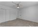 Bedroom with wood-look floors, white walls, a ceiling fan, and closet doors at 701 W Windsor Ave, Phoenix, AZ 85007