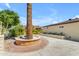 Beige home with mature landscaping and paver driveway with two palm trees in center at 701 W Windsor Ave, Phoenix, AZ 85007
