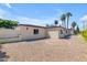Beige home with mature landscaping and paver walkway surrounded by desert landscaping at 701 W Windsor Ave, Phoenix, AZ 85007