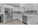 Bright kitchen featuring stainless steel appliances and white cabinets at 701 W Windsor Ave, Phoenix, AZ 85007