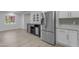 Kitchen with stainless appliances, white cabinets, and gray accent wall at 701 W Windsor Ave, Phoenix, AZ 85007