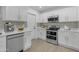 Bright kitchen with white cabinets, stainless steel appliances, and sleek countertops at 701 W Windsor Ave, Phoenix, AZ 85007