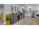 Modern kitchenette with stainless steel appliances, white cabinets, and a wine rack at 701 W Windsor Ave, Phoenix, AZ 85007