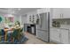 Modern kitchenette with stainless steel appliances, white cabinets, and a dining area at 701 W Windsor Ave, Phoenix, AZ 85007