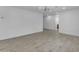 Spacious living room with light grey wood floors, white walls, and ceiling fan at 701 W Windsor Ave, Phoenix, AZ 85007