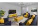 Stylish living room with modern furnishings, a yellow and blue color scheme, and ample natural light at 701 W Windsor Ave, Phoenix, AZ 85007