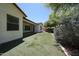 This home features a well-maintained backyard with artificial grass, trees, and an extended covered patio for relaxing at 7126 W Ocotillo Rd, Glendale, AZ 85303
