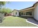 Relax in this backyard featuring an artificial lawn, covered patio, and privacy fence for year-round enjoyment at 7126 W Ocotillo Rd, Glendale, AZ 85303