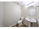 Powder room with pedestal sink, toilet and decorative mirror at 7126 W Ocotillo Rd, Glendale, AZ 85303