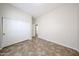 Bedroom featuring tile floors, closet doors and neutral paint at 7126 W Ocotillo Rd, Glendale, AZ 85303