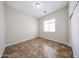 Bright bedroom featuring tile floors and a window for natural light at 7126 W Ocotillo Rd, Glendale, AZ 85303
