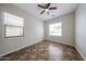 An empty bedroom with windows, a ceiling fan, and tile flooring at 7126 W Ocotillo Rd, Glendale, AZ 85303