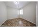 Neutral bedroom with tile flooring, large window, and a closet at 7126 W Ocotillo Rd, Glendale, AZ 85303
