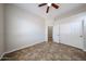 A basic empty bedroom with double sliding door closet and ceiling fan at 7126 W Ocotillo Rd, Glendale, AZ 85303