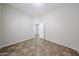 An empty room with tile flooring and an open doorway at 7126 W Ocotillo Rd, Glendale, AZ 85303