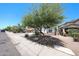 Inviting single-story home featuring desert landscaping, trees, and a well-kept lawn at 7126 W Ocotillo Rd, Glendale, AZ 85303