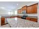 Bright, modern kitchen with granite countertops, wood cabinets, and stainless steel appliances at 7126 W Ocotillo Rd, Glendale, AZ 85303
