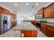 Spacious kitchen with an island, stainless steel appliances, and wood cabinets at 7126 W Ocotillo Rd, Glendale, AZ 85303