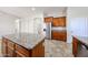Modern kitchen with island, stainless steel refrigerator, granite counters and wood cabinets at 7126 W Ocotillo Rd, Glendale, AZ 85303
