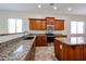 Kitchen featuring wood cabinets, stainless steel appliances, and granite countertops at 7126 W Ocotillo Rd, Glendale, AZ 85303