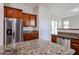Modern kitchen with stainless steel refrigerator, granite counters and wood cabinets at 7126 W Ocotillo Rd, Glendale, AZ 85303