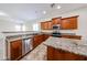 Modern kitchen with stainless steel appliances, granite countertops, and wood cabinets at 7126 W Ocotillo Rd, Glendale, AZ 85303