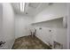 Functional laundry room with utility sink and ample storage options at 7126 W Ocotillo Rd, Glendale, AZ 85303