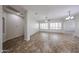Open living room with plantation shutters, neutral walls, and tile flooring at 7126 W Ocotillo Rd, Glendale, AZ 85303