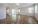 Open living room with tile floors, natural light from sliding glass door, and neutral walls at 7126 W Ocotillo Rd, Glendale, AZ 85303