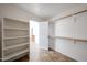 Walk-in closet featuring custom shelving and open door at 7126 W Ocotillo Rd, Glendale, AZ 85303