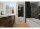 Modern bathroom featuring a sleek vanity, tub, and shower with elegant black and white tile at 7137 E Rancho Vista Dr # 3007, Scottsdale, AZ 85251