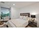 Charming bedroom featuring a comfortable bed, modern nightstands, and a relaxing sitting area with leafy green outdoors at 7137 E Rancho Vista Dr # 3007, Scottsdale, AZ 85251