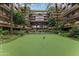 Lush courtyard with palm trees, green turf, and a central water feature at 7137 E Rancho Vista Dr # 3007, Scottsdale, AZ 85251