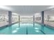 Large indoor pool with natural light, ceiling fans, lounge chairs, and tile flooring at 7137 E Rancho Vista Dr # 3007, Scottsdale, AZ 85251