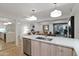 Modern kitchen featuring stone countertops, stainless steel appliances, and pendant lighting, seamlessly flowing into the living area at 7137 E Rancho Vista Dr # 3007, Scottsdale, AZ 85251